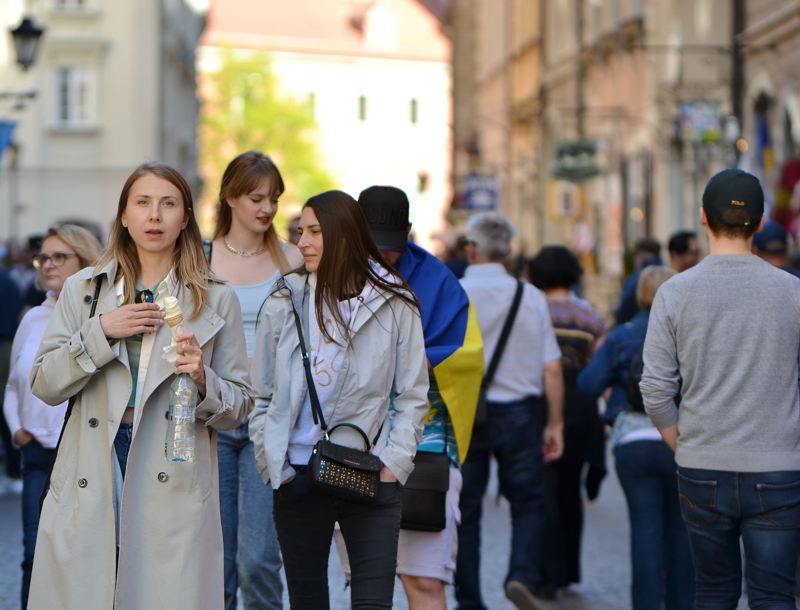 4 - A crowd of people walking down a historic street in Warsaw
